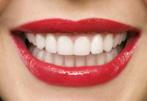 Woman smiling, close-up of mouth, red lips